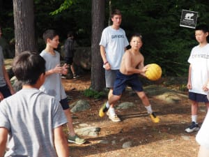 Campers initiate a ball game while waiting down at the waterfront