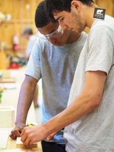 Camper is instructed on how to properly use tools in Woodworking industry