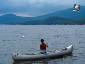 Camper practices canoeing solo as he works towards the "Red Ribbon" or canoeing ribbon