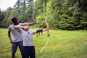 Boys learning archery at Camp Mowglis